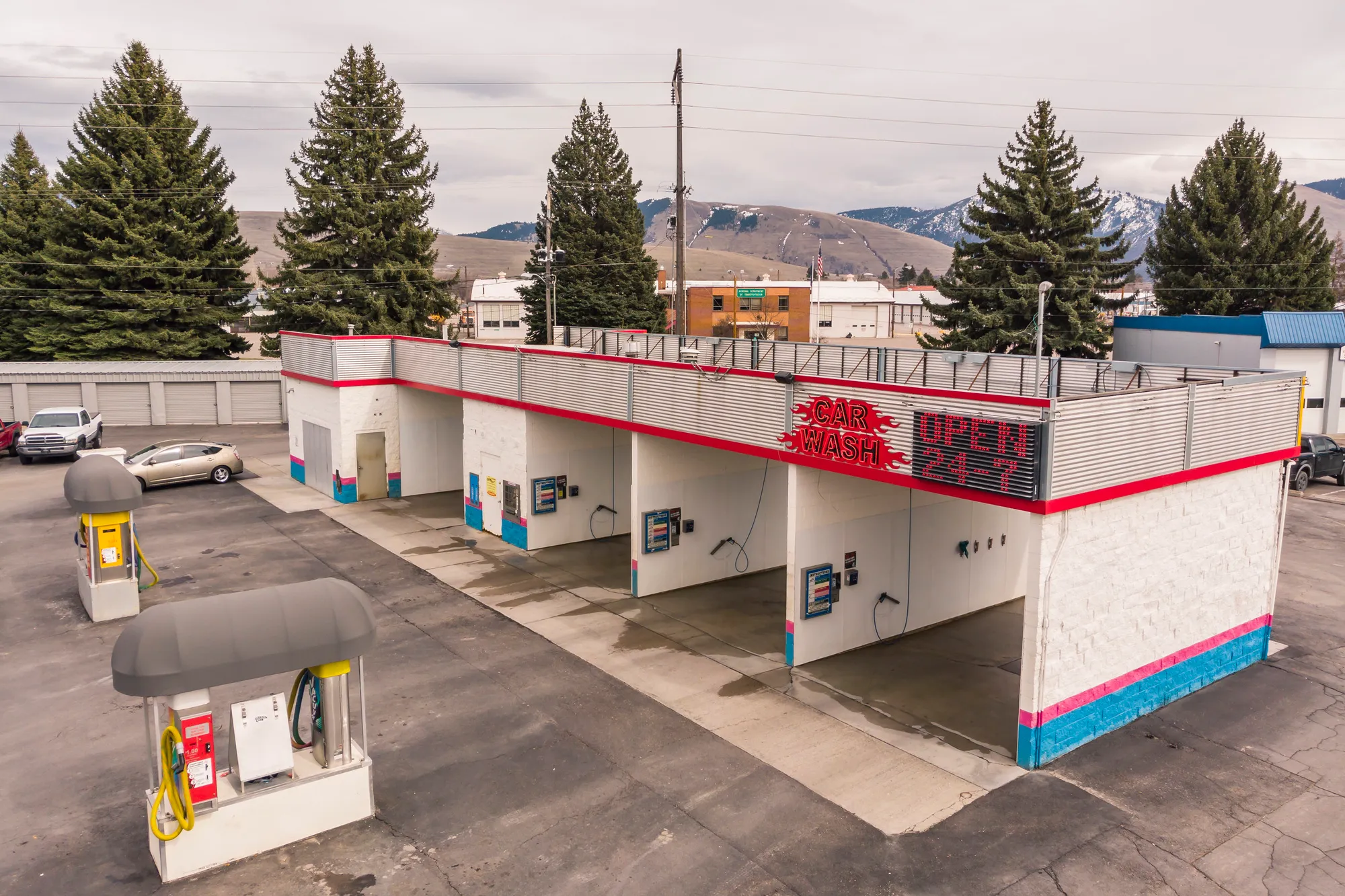 Self-serve car wash with covered wash bays