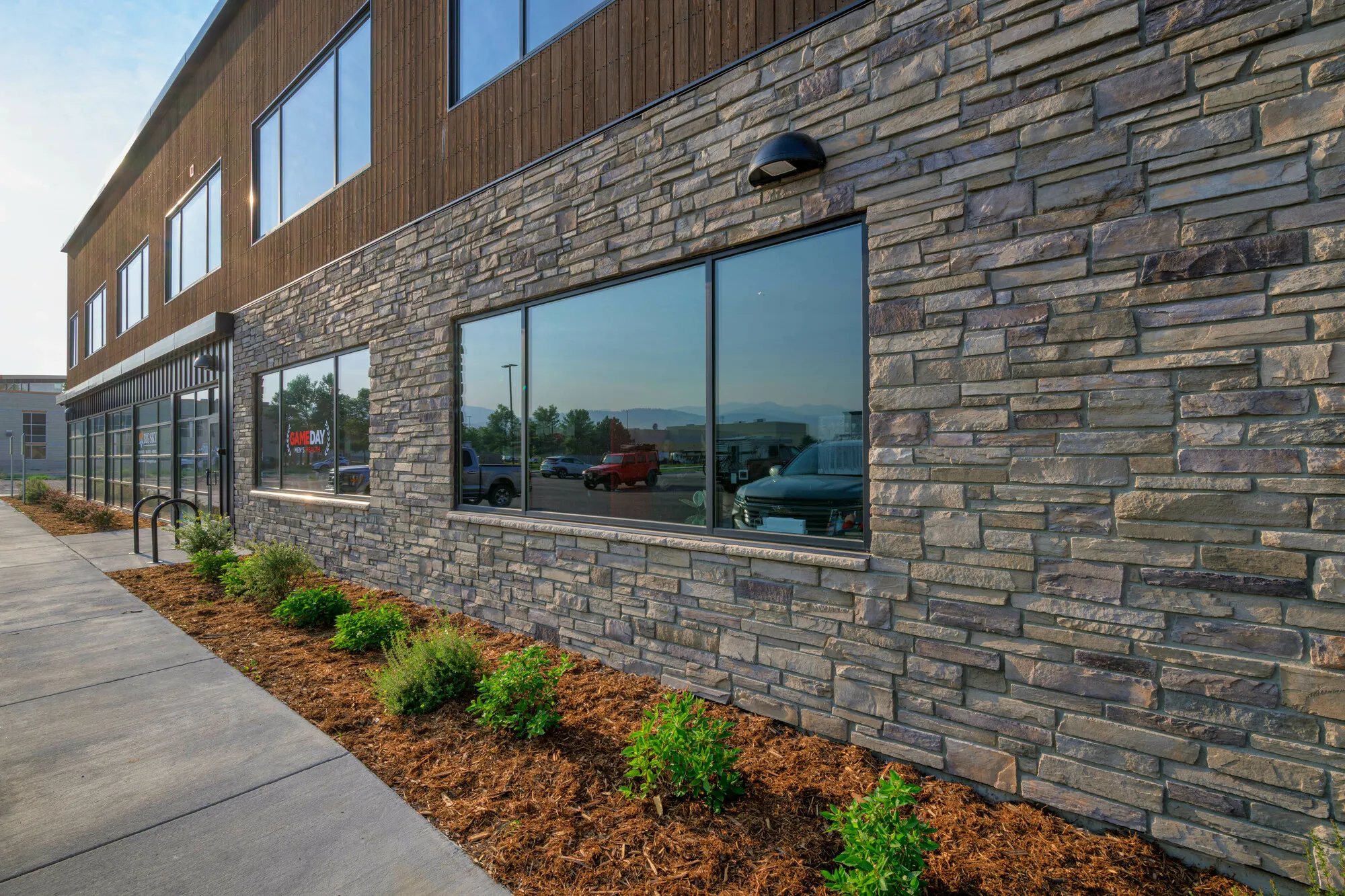 Commercial building with a stone and wood exterior and a landscaped walkway